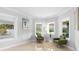 Bright sitting area with matching chairs, accent table, and expansive windows offering serene views at 1415 Brumley Rd, Chuluota, FL 32766