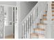 Elegant staircase with white banisters and wood treads, leading to the upper level of the home at 1415 Brumley Rd, Chuluota, FL 32766