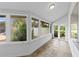 Bright sunroom with tiled floors, light walls and a view of the back yard at 1415 Brumley Rd, Chuluota, FL 32766
