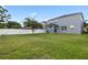 Expansive backyard with vibrant green lawn, privacy fence, and covered patio at 15210 Montesino Dr, Orlando, FL 32828