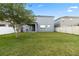 Well-maintained backyard with lush green grass, white fencing, and patio area at 15210 Montesino Dr, Orlando, FL 32828