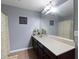 Bathroom with a large mirror, and a long vanity with a beige countertop, and warm color palette at 15210 Montesino Dr, Orlando, FL 32828