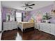 Charming bedroom with hardwood floors, natural light, and ample dresser space at 15210 Montesino Dr, Orlando, FL 32828