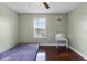 Simple bedroom offers sleek wood floors, a functional vanity, and a window overlooking the greenery at 15210 Montesino Dr, Orlando, FL 32828