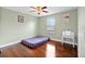 Bright bedroom features wood floors, a vanity, and a ceiling fan, creating a cozy atmosphere at 15210 Montesino Dr, Orlando, FL 32828