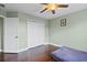 Well-lit bedroom equipped with a closet and a ceiling fan above the sleek hardwood flooring at 15210 Montesino Dr, Orlando, FL 32828