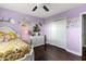 Charming bedroom features a decorative bed, a white dresser, and a closet with bi-fold doors at 15210 Montesino Dr, Orlando, FL 32828