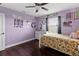 Stylish bedroom with unique decor, beautiful wood floors, and a ceiling fan for added comfort at 15210 Montesino Dr, Orlando, FL 32828