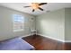 Inviting bedroom with wood floors, a bright window, and sleek wood floors for a modern feel at 15210 Montesino Dr, Orlando, FL 32828