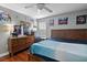 Comfortable bedroom featuring a wooden bed frame, laminated floors and decorative walls at 15210 Montesino Dr, Orlando, FL 32828