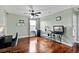 Well-lit bonus room with hardwood floors, a ceiling fan, and light green walls at 15210 Montesino Dr, Orlando, FL 32828