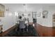Open-concept dining room featuring hardwood floors, modern furnishings, and natural light at 15210 Montesino Dr, Orlando, FL 32828