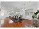 Stylish dining area boasts wood floors, a modern chandelier, and a large window at 15210 Montesino Dr, Orlando, FL 32828