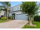 Beautiful two-story house with a brick-paved driveway, a well-manicured lawn, and colorful shrubs at 15210 Montesino Dr, Orlando, FL 32828