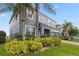 Inviting two-story home with lush landscaping, mature palm trees, and a brick-paved driveway at 15210 Montesino Dr, Orlando, FL 32828