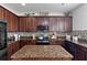 Beautiful kitchen with dark wood cabinets, granite countertops, and stainless steel appliances at 15210 Montesino Dr, Orlando, FL 32828