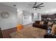 Open-concept living room with a brown leather sectional sofa and views of the stairs at 15210 Montesino Dr, Orlando, FL 32828