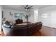 Inviting living room with a sleek ceiling fan and a comfortable brown leather sectional sofa at 15210 Montesino Dr, Orlando, FL 32828