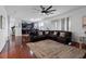 Open-concept living room with a brown leather sectional sofa and views of the kitchen at 15210 Montesino Dr, Orlando, FL 32828