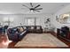 Spacious living room with a brown leather sectional sofa and a large area rug at 15210 Montesino Dr, Orlando, FL 32828