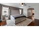 Spacious bedroom with elegant gray accents and an archway into a bathroom at 15210 Montesino Dr, Orlando, FL 32828