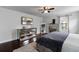 Well-lit bedroom with a large window, hardwood floors, and mirrored dressers at 15210 Montesino Dr, Orlando, FL 32828