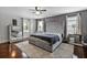 Bright bedroom with luxury bed and decor, featuring large windows and neutral paint at 15210 Montesino Dr, Orlando, FL 32828