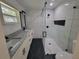 Renovated bathroom features dual vanity and glass enclosed shower with modern black hardware at 16742 Se 165Th Ave, Weirsdale, FL 32195