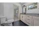 Bathroom showcasing granite countertops, white cabinets, and modern fixtures at 16742 Se 165Th Ave, Weirsdale, FL 32195