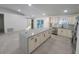 Bright, open kitchen featuring a large island, stainless steel appliances, and sliding doors at 16742 Se 165Th Ave, Weirsdale, FL 32195