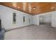 Bright and spacious living room with a wood-paneled ceiling and large windows at 16742 Se 165Th Ave, Weirsdale, FL 32195