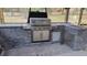 Modern outdoor kitchen with stone accents, built in sink, and stainless steel appliances at 16742 Se 165Th Ave, Weirsdale, FL 32195