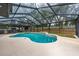 Inviting in-ground pool enclosed by a screened lanai, perfect for outdoor enjoyment at 16742 Se 165Th Ave, Weirsdale, FL 32195