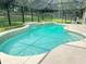 Sparkling blue in-ground pool with a tiled edge surrounded by a spacious concrete patio at 16742 Se 165Th Ave, Weirsdale, FL 32195