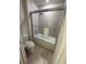 Clean bathroom featuring a shower-tub combo with a glass sliding door and a white toilet at 197 Jetty Way, Davenport, FL 33897