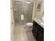 Modern bathroom with a glass-enclosed shower, granite vanity, and sleek fixtures at 197 Jetty Way, Davenport, FL 33897