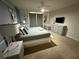 Modern bedroom with carpet, ceiling fan, and platform bed with stylish gray bedding at 197 Jetty Way, Davenport, FL 33897