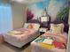 Charming bedroom featuring dual beds with princess themed bedding and mural at 197 Jetty Way, Davenport, FL 33897