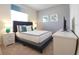 Comfortable bedroom with a plush bed, stylish headboard, neutral wall color, and decorative bedside lamps at 197 Jetty Way, Davenport, FL 33897