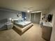 Modern bedroom with carpet, ceiling fan, and platform bed with stylish gray bedding at 197 Jetty Way, Davenport, FL 33897