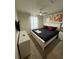 Cozy bedroom with light green walls, a bed with red pillows, and modern artwork at 197 Jetty Way, Davenport, FL 33897
