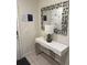Stylish entryway with a modern console table, decorative mirror, and pristine white walls at 197 Jetty Way, Davenport, FL 33897