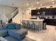 The kitchen features a large island, modern appliances, and an open layout to the living area at 197 Jetty Way, Davenport, FL 33897