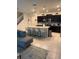 The kitchen has a large island with bar seating, dark cabinets, and stainless steel appliances at 197 Jetty Way, Davenport, FL 33897