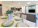 Open-concept living area with a dining table, living room, and a kitchen with modern finishes at 197 Jetty Way, Davenport, FL 33897