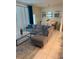 Cozy living area with grey sectional sofa, modern decor, and an adjacent dining area at 197 Jetty Way, Davenport, FL 33897