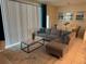 Comfortable living room features a gray sectional sofa, modern coffee table, and large windows for natural light at 197 Jetty Way, Davenport, FL 33897
