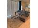 Bright living room with a comfortable gray couch, stylish coffee table and large window at 197 Jetty Way, Davenport, FL 33897