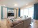 Bright living room boasts recessed lighting, a large sofa, and access to the screened patio at 197 Jetty Way, Davenport, FL 33897