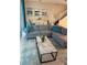 Open-concept living area with comfortable seating, modern decor, and staircase access at 197 Jetty Way, Davenport, FL 33897